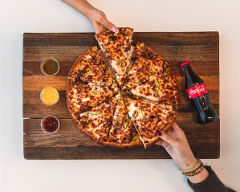 A cheese pizza being pulled apart