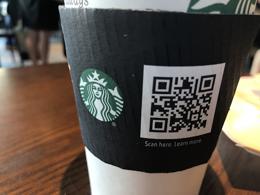 A QR code on a Starbucks coffee cup